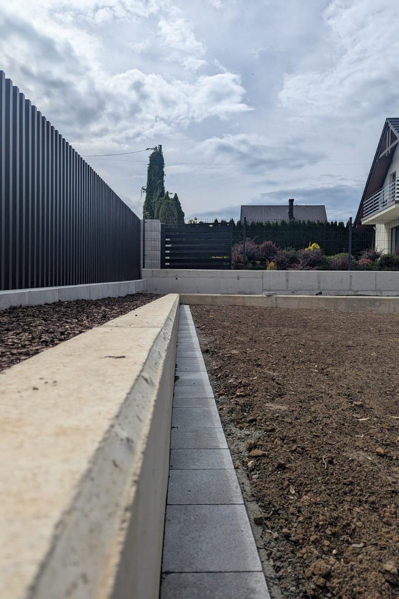 Przygotowana rabata ze ściółką z kory, oświetleniem i nawadnianiem
